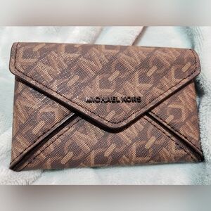 614. Michael Kors Brown Monogram Clutch